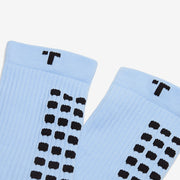 Pair of light blue socks with black pattern on a white background