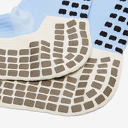 Close-up of textured socks with a grid pattern on a white background
