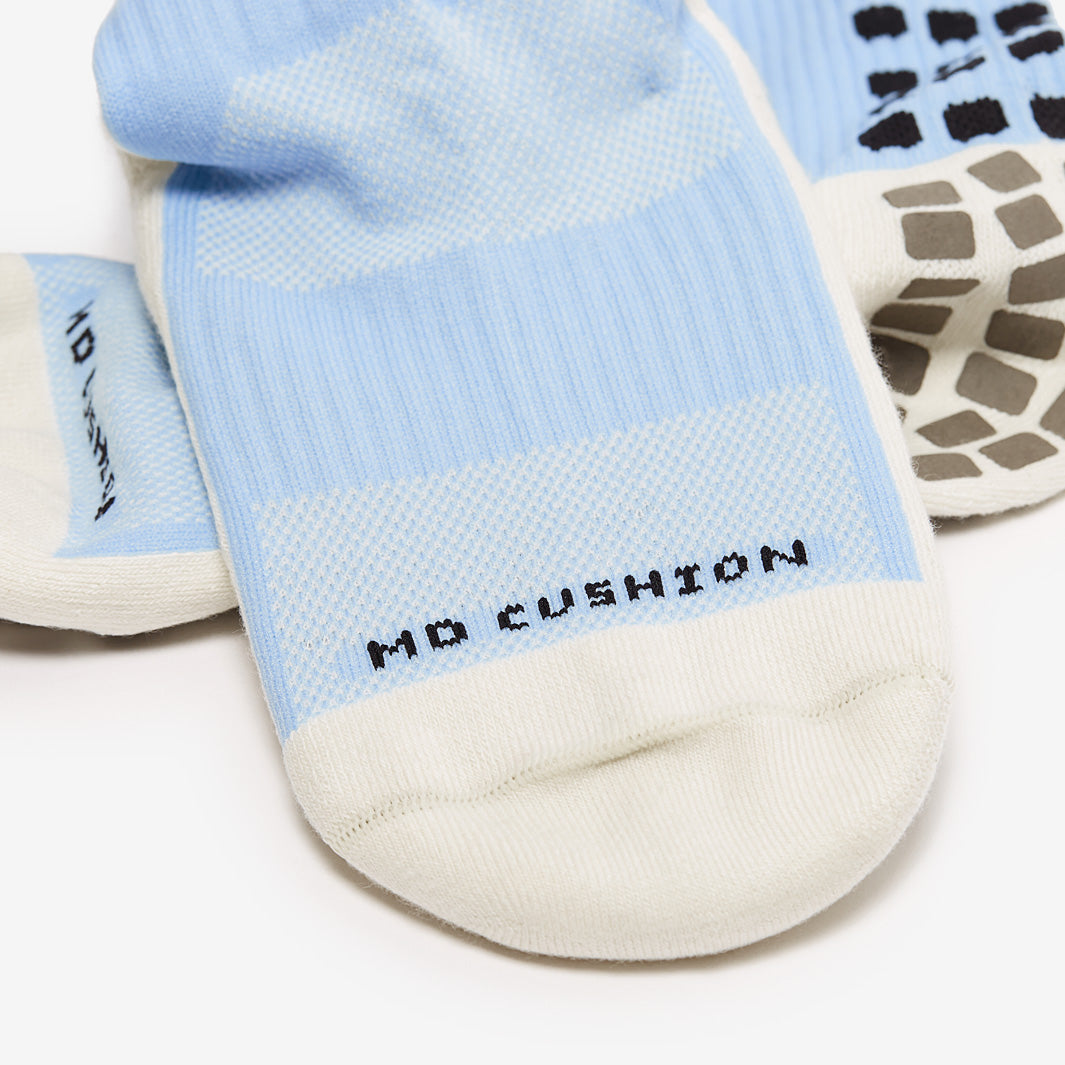 Light blue and white socks with 'No Cushion' label on a white background
