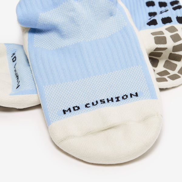 Light blue and white socks with 'No Cushion' label on a white background