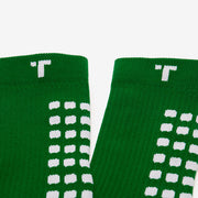Close-up of green socks with white pattern on a white background
