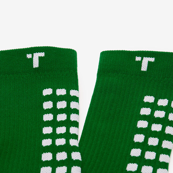 Close-up of green socks with white pattern on a white background