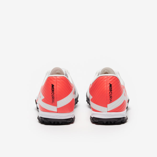 Pair of red and white football shoes with 'Mercurial' branding on a white background