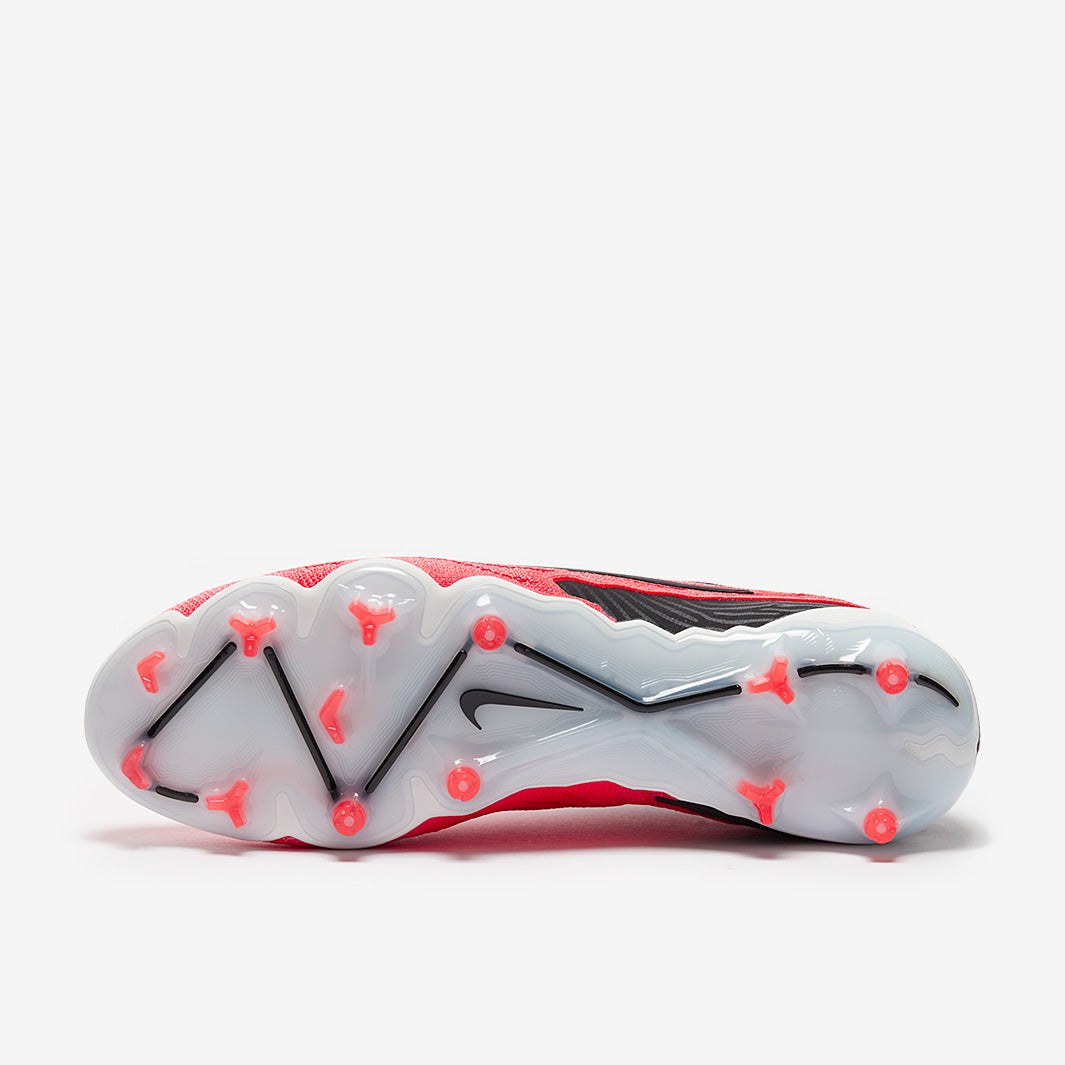 Sole of a football boot with red and black design on a white background