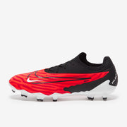 Red and black football boot with white sole on a white background