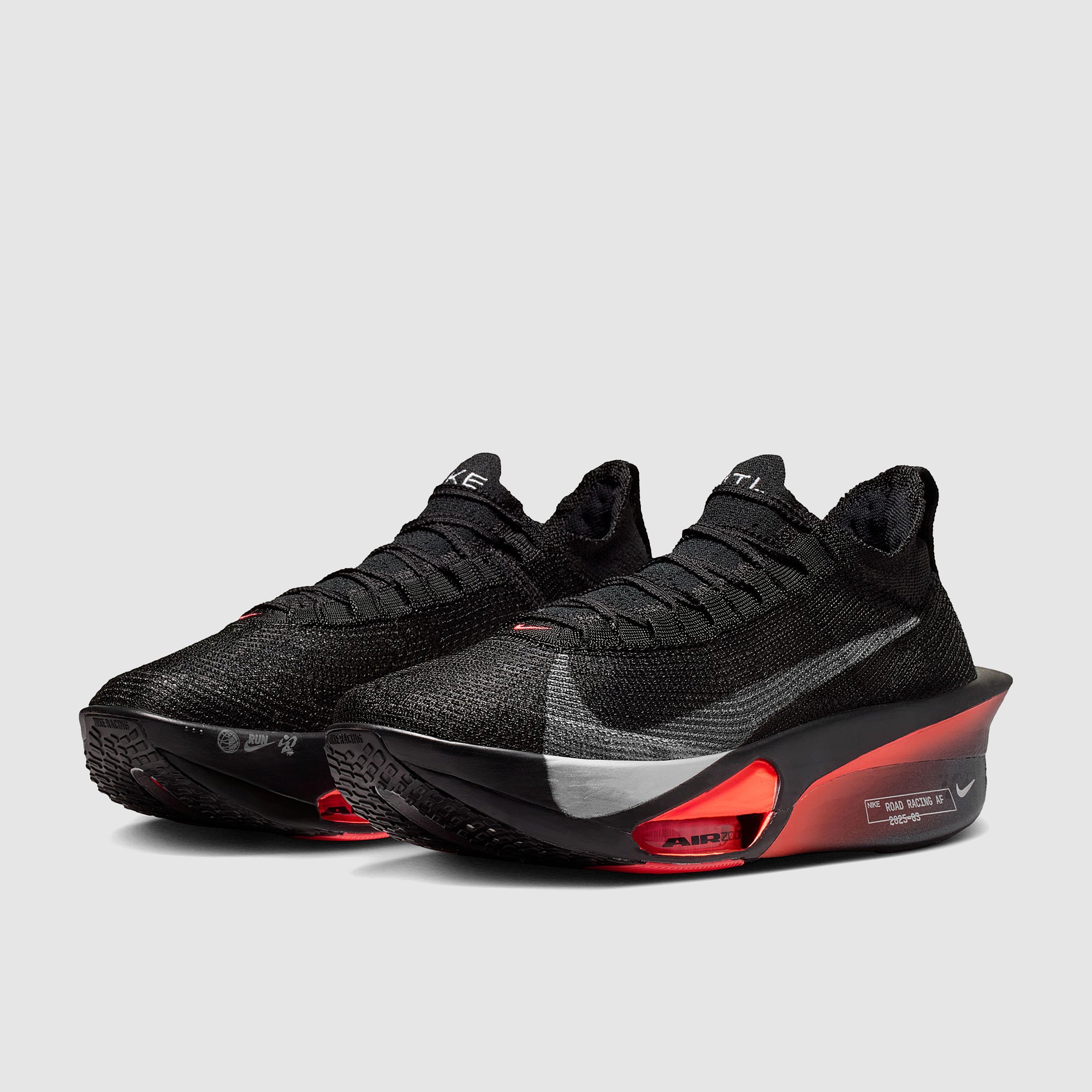 Black and red athletic shoes on a light gray background