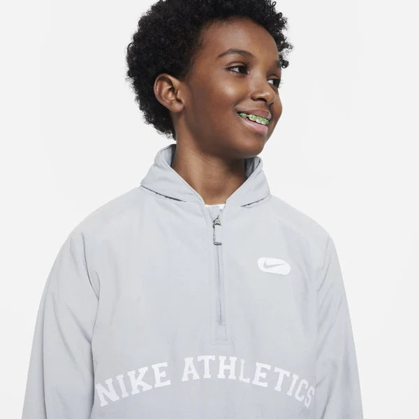 Person wearing a gray Nike Athletics hoodie on a white background