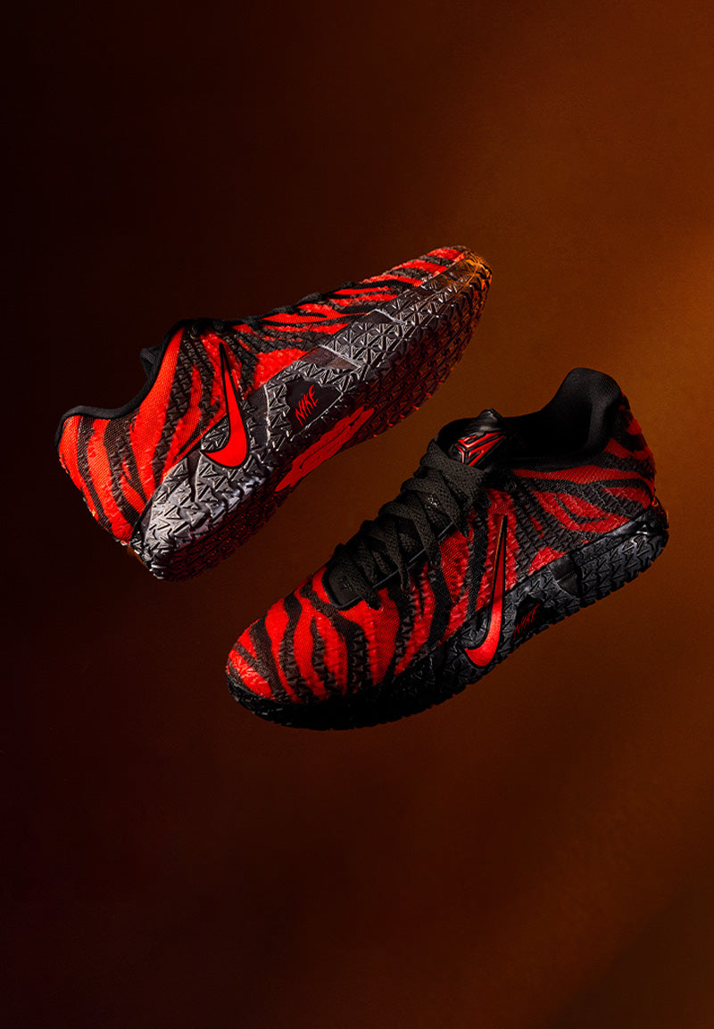 Nike Ja Animal Pack red and black shoes on a reddy brown background 