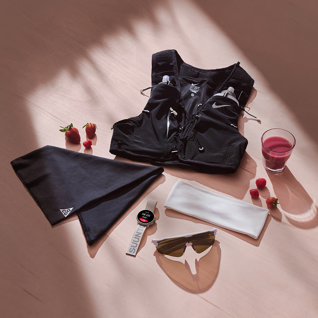 Black athletic outfit with accessories on a wooden surface