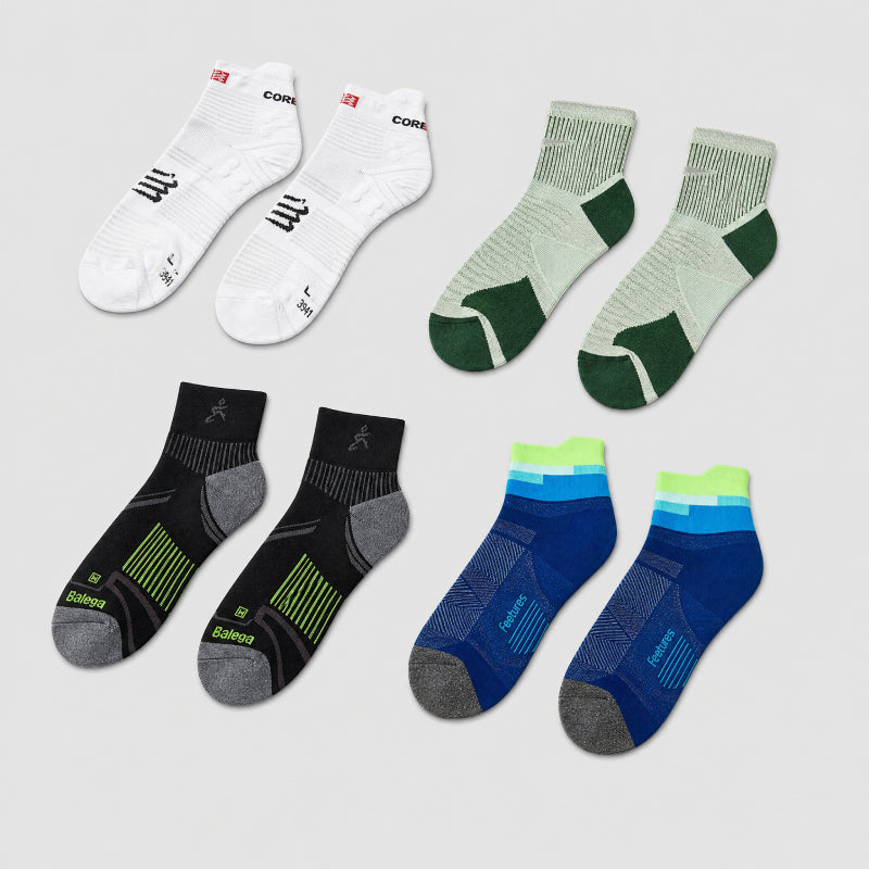 Set of six pairs of socks in different colors on a light gray background