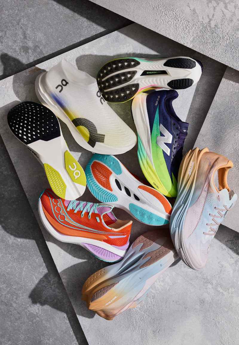Colorful running shoes arranged on a gray surface
