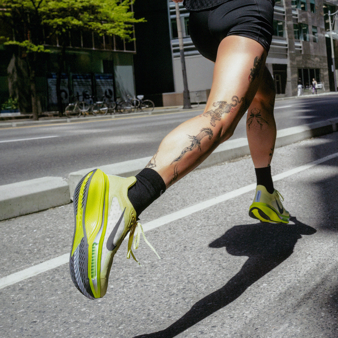 person running in yellow nike running trainers 